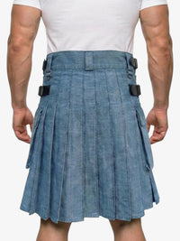 Person wearing a blue denim kilt on a white background