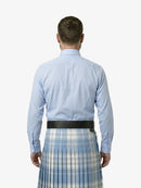 Man wearing a light blue shirt and plaid kilt on a white background