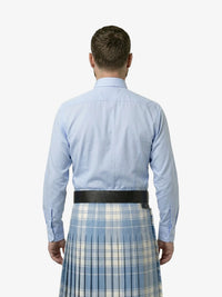 Man wearing a light blue shirt and plaid kilt on a white background