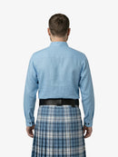 Man wearing a blue shirt and plaid kilt on a white background