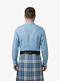 Man wearing a blue shirt and plaid kilt on a white background