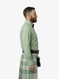 Man wearing a green shirt and plaid kilt on a white background