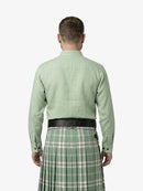 Man wearing a green shirt and plaid kilt on a white background
