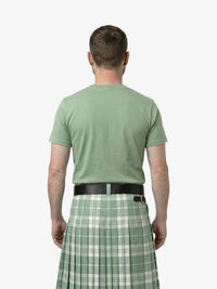 Man wearing a green t-shirt and plaid kilt on a white background