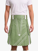 A man wearing a sage green kilt with white geometric stripe details and silver-tone hardware, paired with a white t-shirt, shown from the chest down against a light gray background.