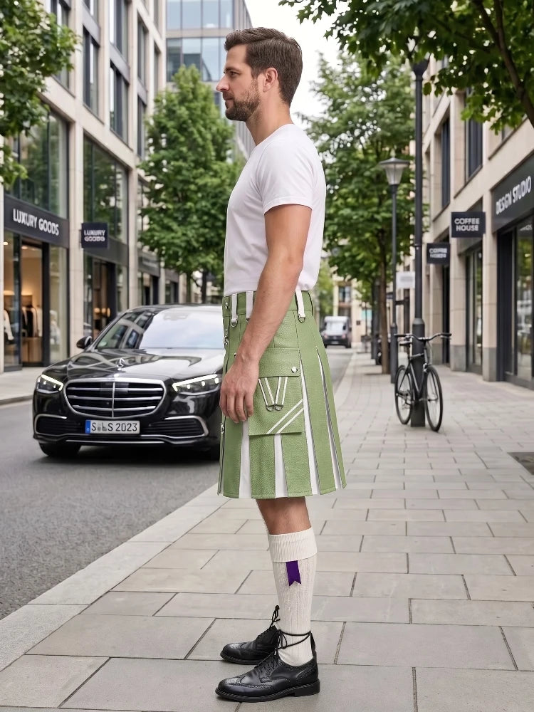 A man standing on a city sidewalk wearing a light green kilt with white vertical stripes, a white t-shirt, white socks, and black leather shoes. A black Mercedes-Benz car and a bicycle are parked on the street behind him.