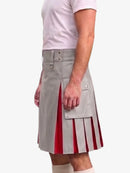 A man wearing a light gray pleated kilt with red striped inner panels, paired with a white t-shirt and white socks, shown from the chest down against a plain white background.
