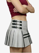 Person wearing a gray pleated skirt with black straps and stripes on a white background
