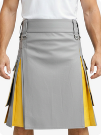 Gray and yellow kilt worn by a person on a plain background