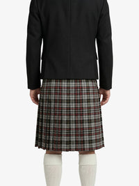 Person wearing a black jacket and plaid skirt on a white background