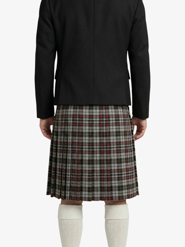 Person wearing a black jacket and plaid skirt on a white background
