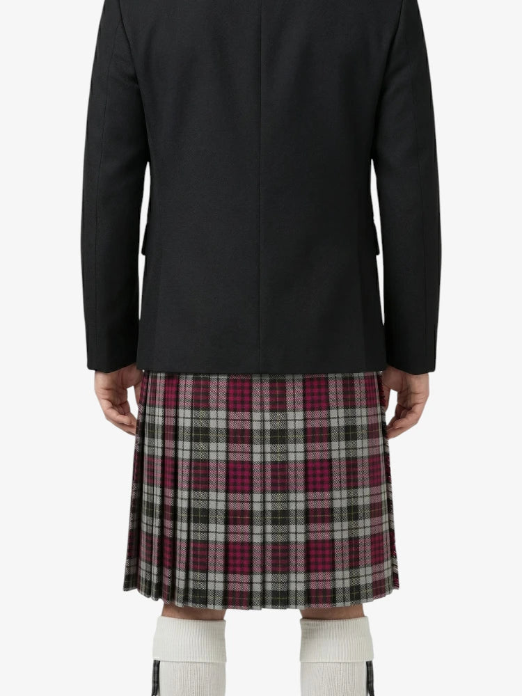 Person wearing a black coat and plaid kilt on a white background