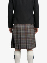 Person wearing a black jacket and plaid kilt on a white background