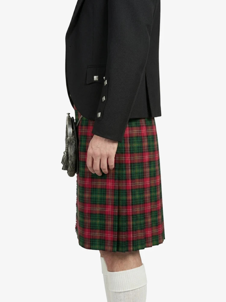 Person wearing a black jacket and red plaid kilt on a white background