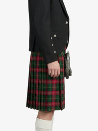 Person wearing a black jacket and red plaid kilt on a white background