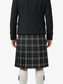Person wearing a black jacket and plaid kilt on a white background