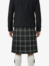 Person wearing a black jacket and plaid kilt on a white background