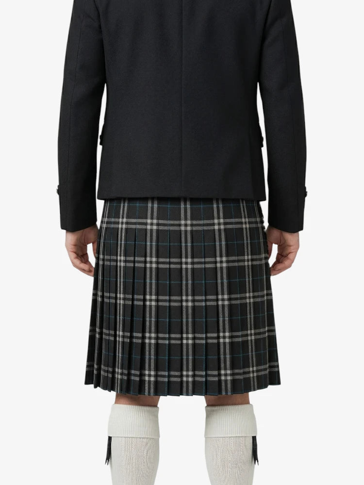 Person wearing a black jacket and plaid kilt on a white background