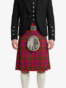 Person wearing a red tartan kilt with a black jacket on a white background
