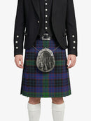 Person wearing a Scottish kilt with a tartan pattern on a white background