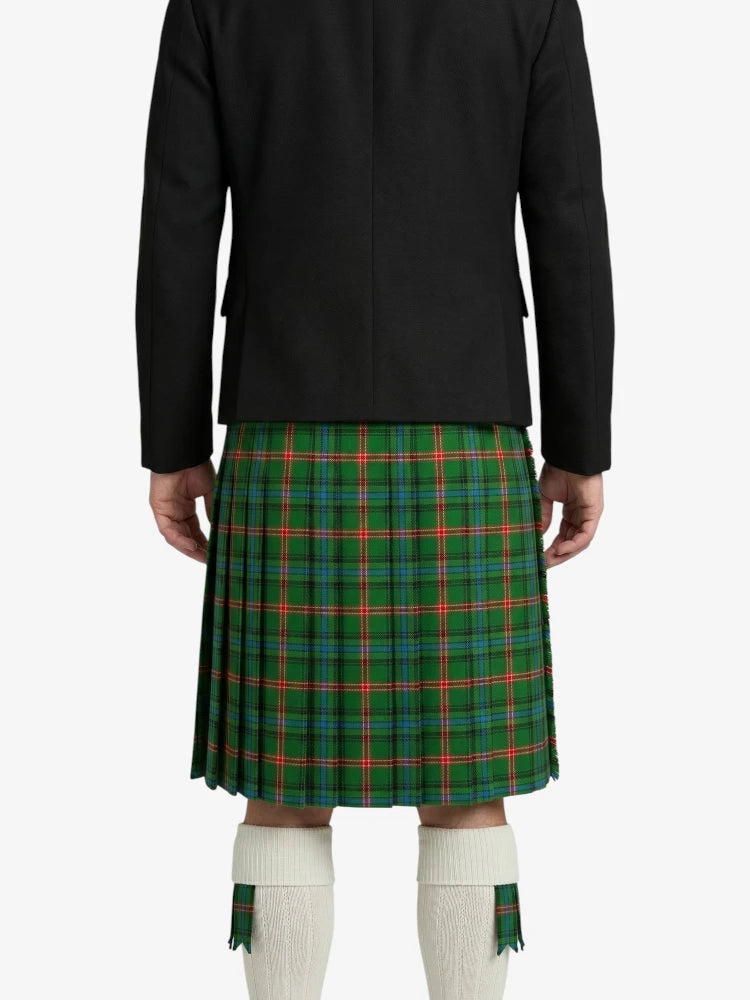 Person wearing a green plaid kilt with a black jacket on a white background