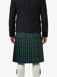 Person wearing a black jacket and green plaid kilt on a white background