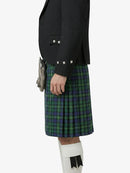 Person wearing a black jacket and green plaid kilt on a white background