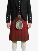 Person wearing a red tartan kilt with a black jacket on a white background