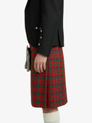 Person wearing a black jacket and red plaid skirt on a white background