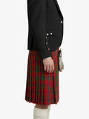 Person wearing a black jacket and red plaid kilt on a white background