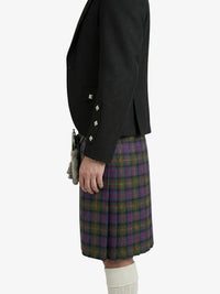 Person wearing a black jacket and plaid skirt on a white background