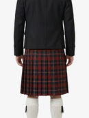 Person wearing a black jacket and red plaid kilt on a white background