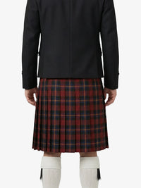 Person wearing a black jacket and red plaid kilt on a white background