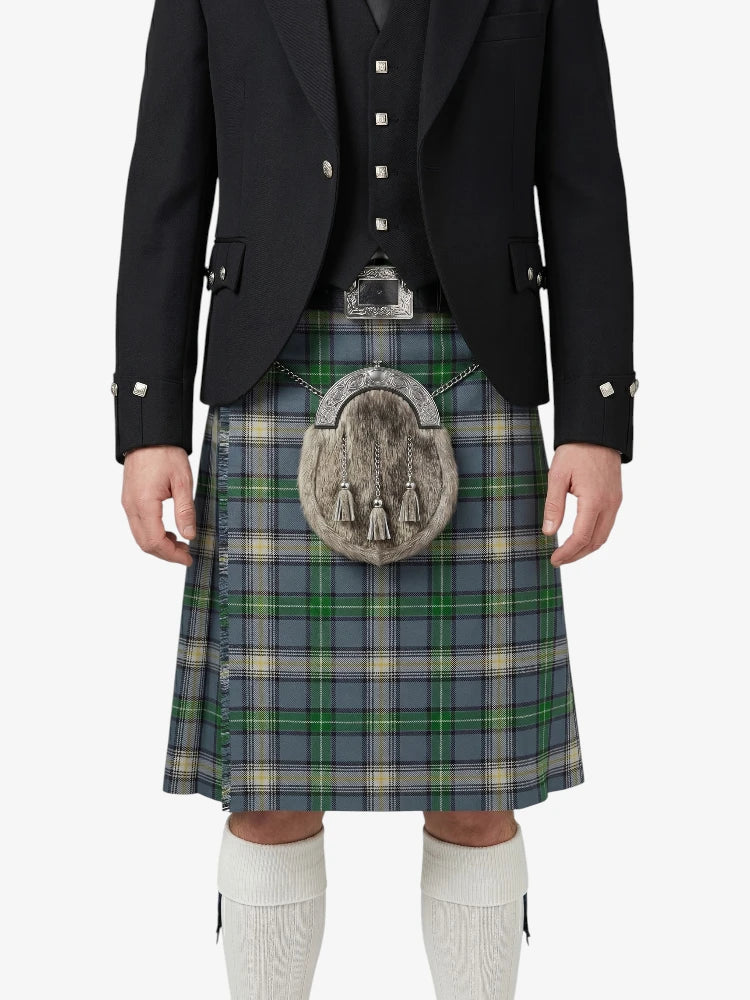 Person wearing a traditional Scottish kilt with a jacket on a white background
