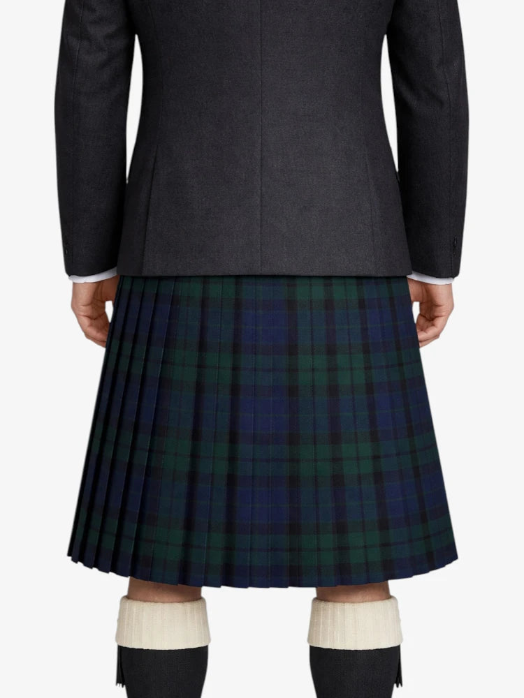Person wearing a dark gray jacket and a green plaid kilt on a white background