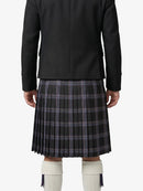 Person wearing a black jacket and plaid kilt on a white background