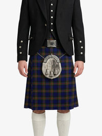 Person wearing a traditional Scottish kilt with a dark jacket on a white background