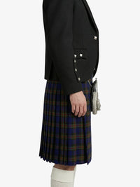 Person wearing a black blazer and plaid kilt on a white background