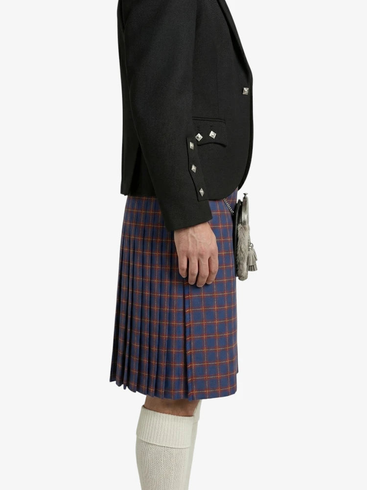 Person wearing a black blazer and red plaid kilt on a white background