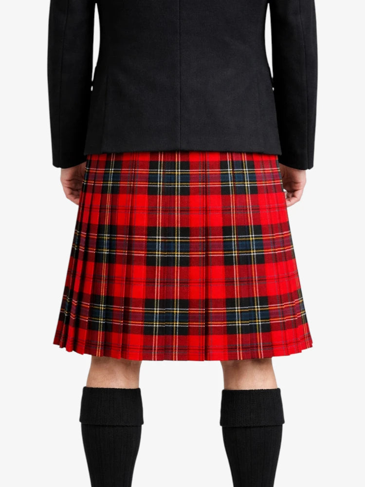 Person wearing a red plaid kilt with a black jacket on a white background