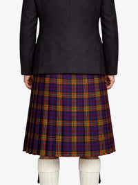 Person wearing a black  jacket and plaid kilt on a white background
