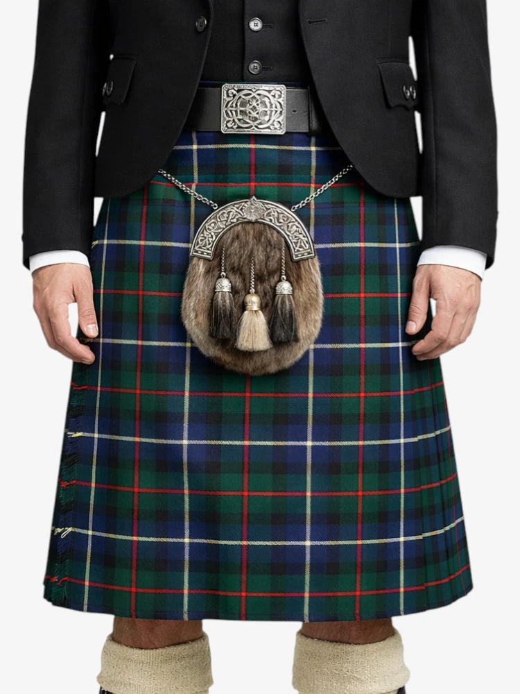 Person wearing a traditional Scottish kilt with a tartan pattern on a white background