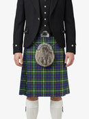 Person wearing a traditional Scottish kilt with a tartan pattern on a white background