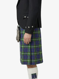 Person wearing a black jacket and green plaid kilt on a white background