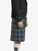Person wearing a black jacket and blue and green plaid kilt on a white background