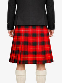 Person wearing a black coat and red plaid kilt with white socks on a white background
