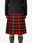 Person wearing a black jacket and red plaid kilt on a white background