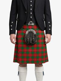 Person wearing a red and green plaid kilt with a black jacket on a white background