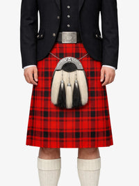 Person wearing a red tartan kilt with a black jacket and white knee-high socks on a white background
