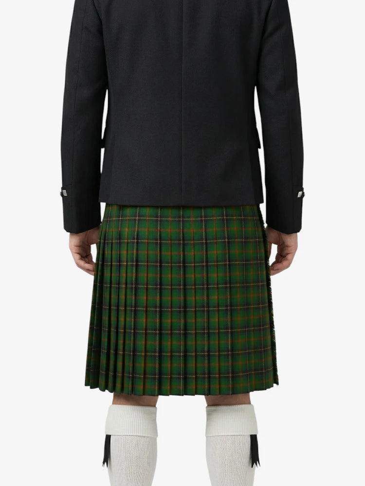 Person wearing a black jacket and green plaid kilt on a white background